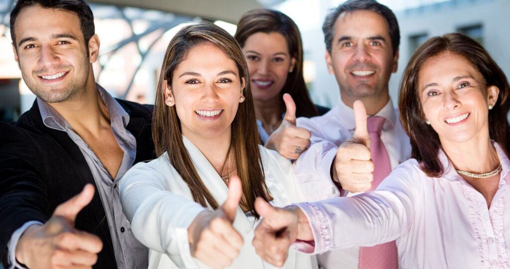 Happy business team with thumbs up and smiling