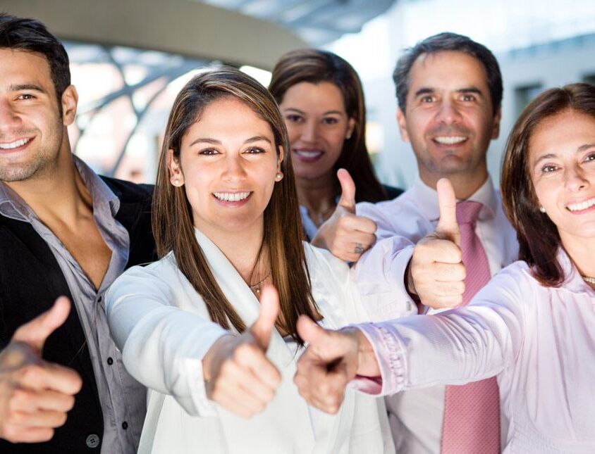 Happy business team with thumbs up and smiling