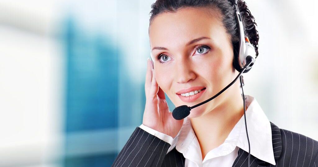 Woman wearing headset in office; could be receptionist