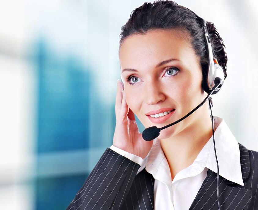 Woman wearing headset in office; could be receptionist