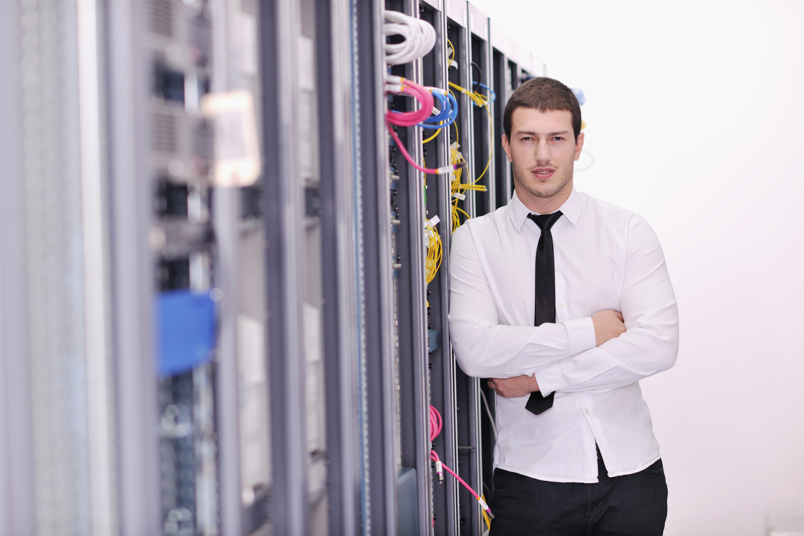 young handsome business man it  engeneer in datacenter server room